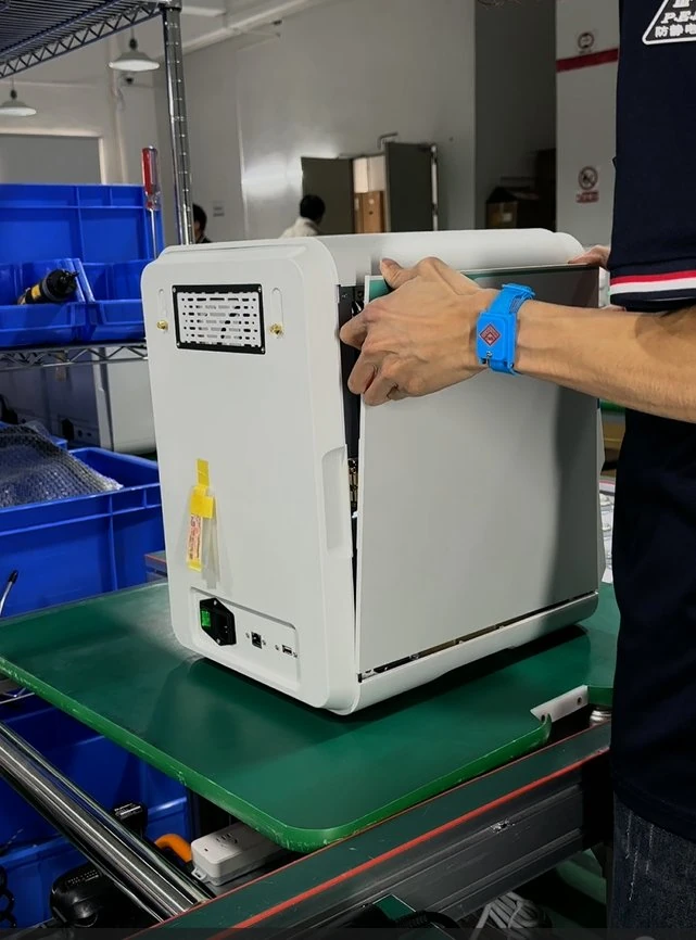 Technician fitting the external enclosure to a veterinary diagnostic analyzer